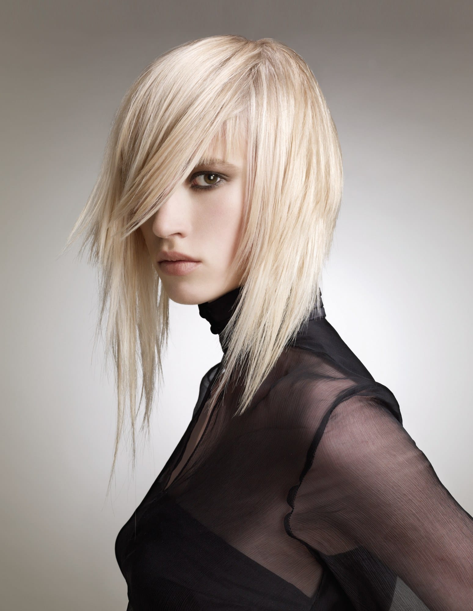 Sleek liquid-smooth platinum blonde with a razor-sharp side-swept fringe – Essensuals Evolution by Stephen Fordham