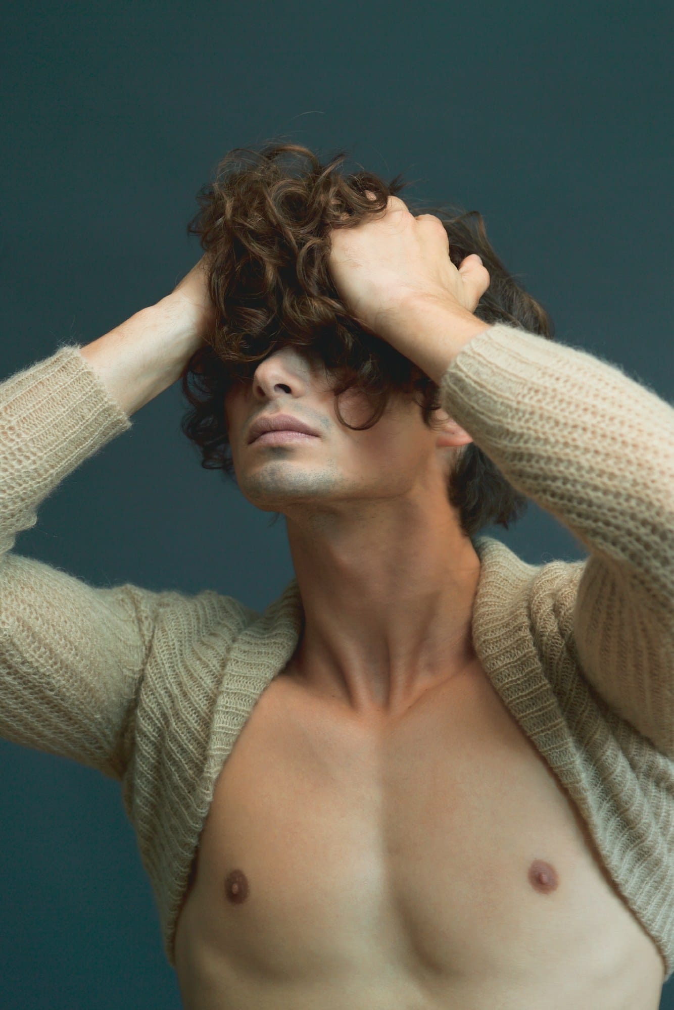 Tousled brown waves with natural movement, hands in hair – Rafal Gaweda hair collection