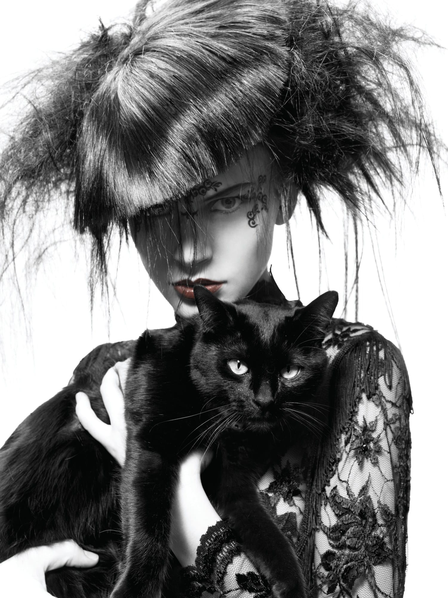 Cropped textured black hairstyle with feathered layers, styled with a black cat and lace sleeve – TIGI Collections, Anthony Mascolo 2007