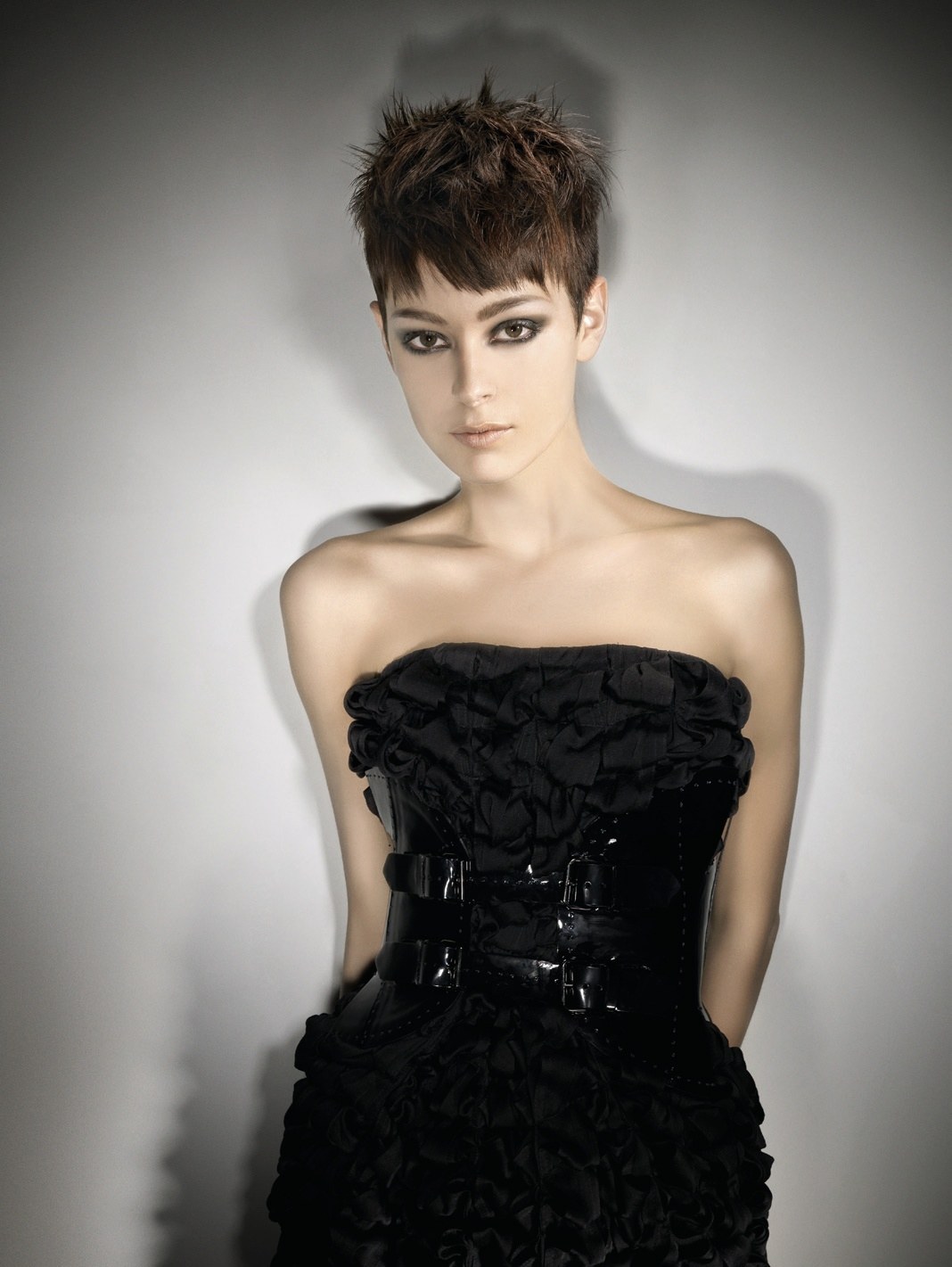 Short dark pixie cut with spiky texture, black ruffled dress – British Hairdresser of the Year, Akin Konizi 2008