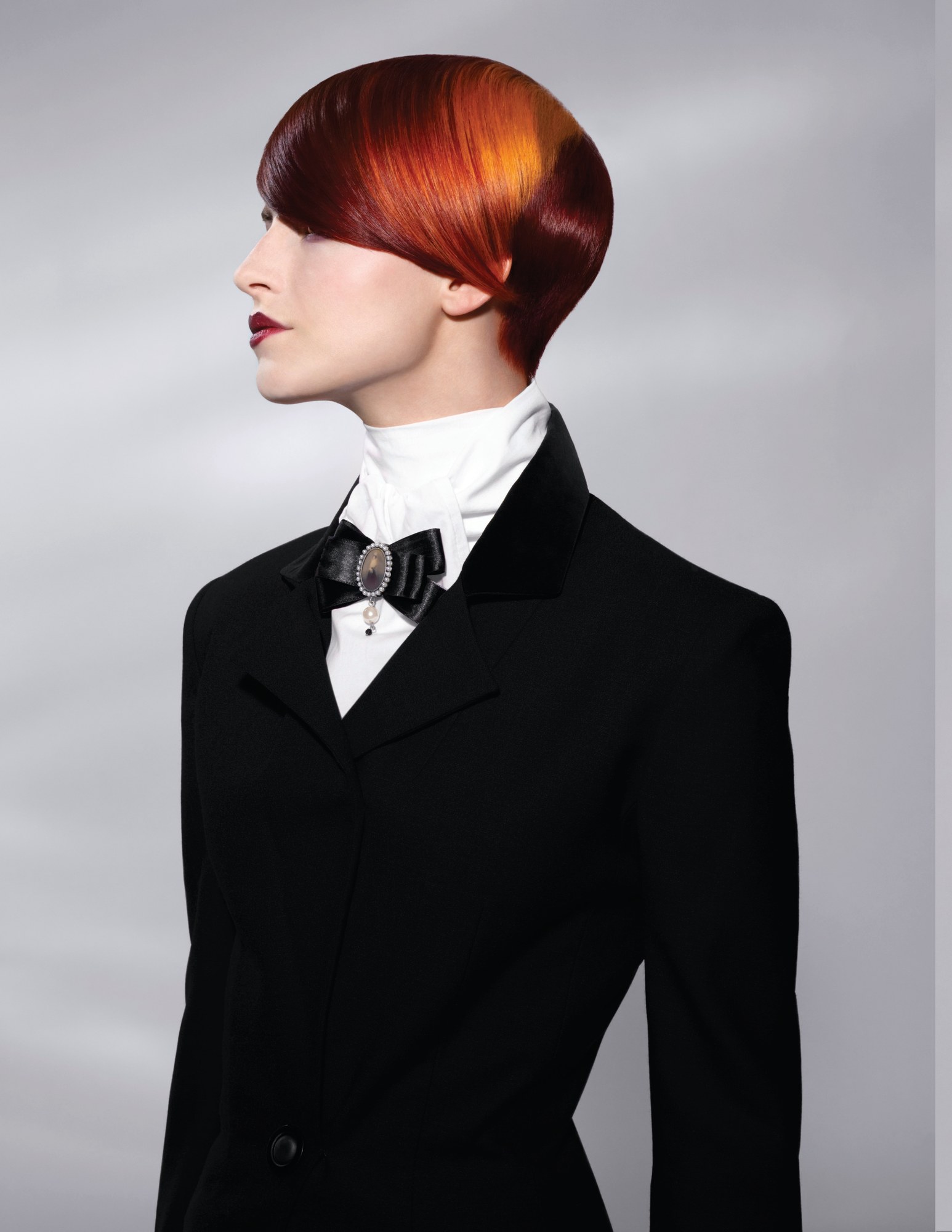 Glossy red and copper bowl shape in profile, black riding jacket – Gilded Youth Collection, Sassoon 2008